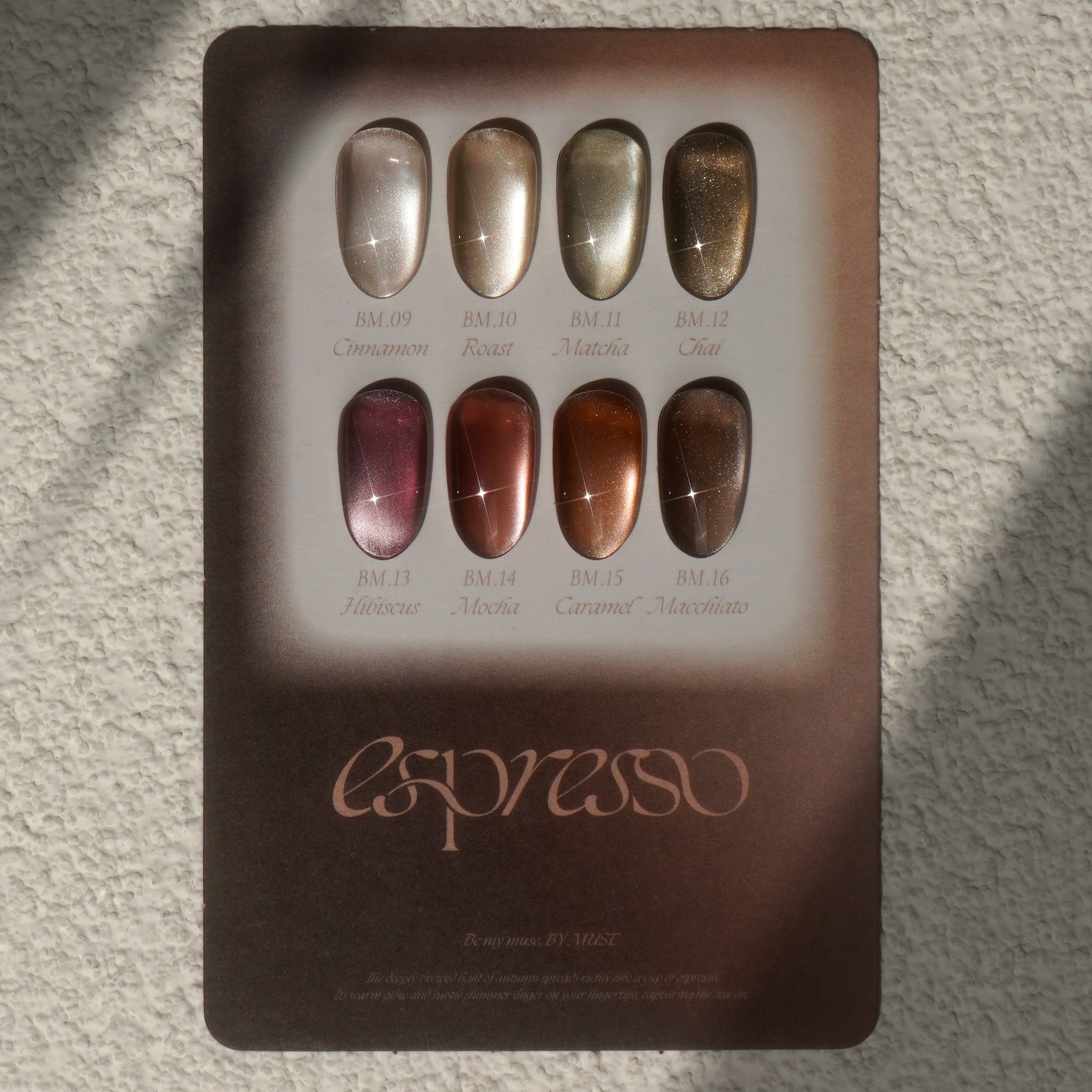 Set of nail polish samples in a metallic case with 'espresso' branding on a textured surface.