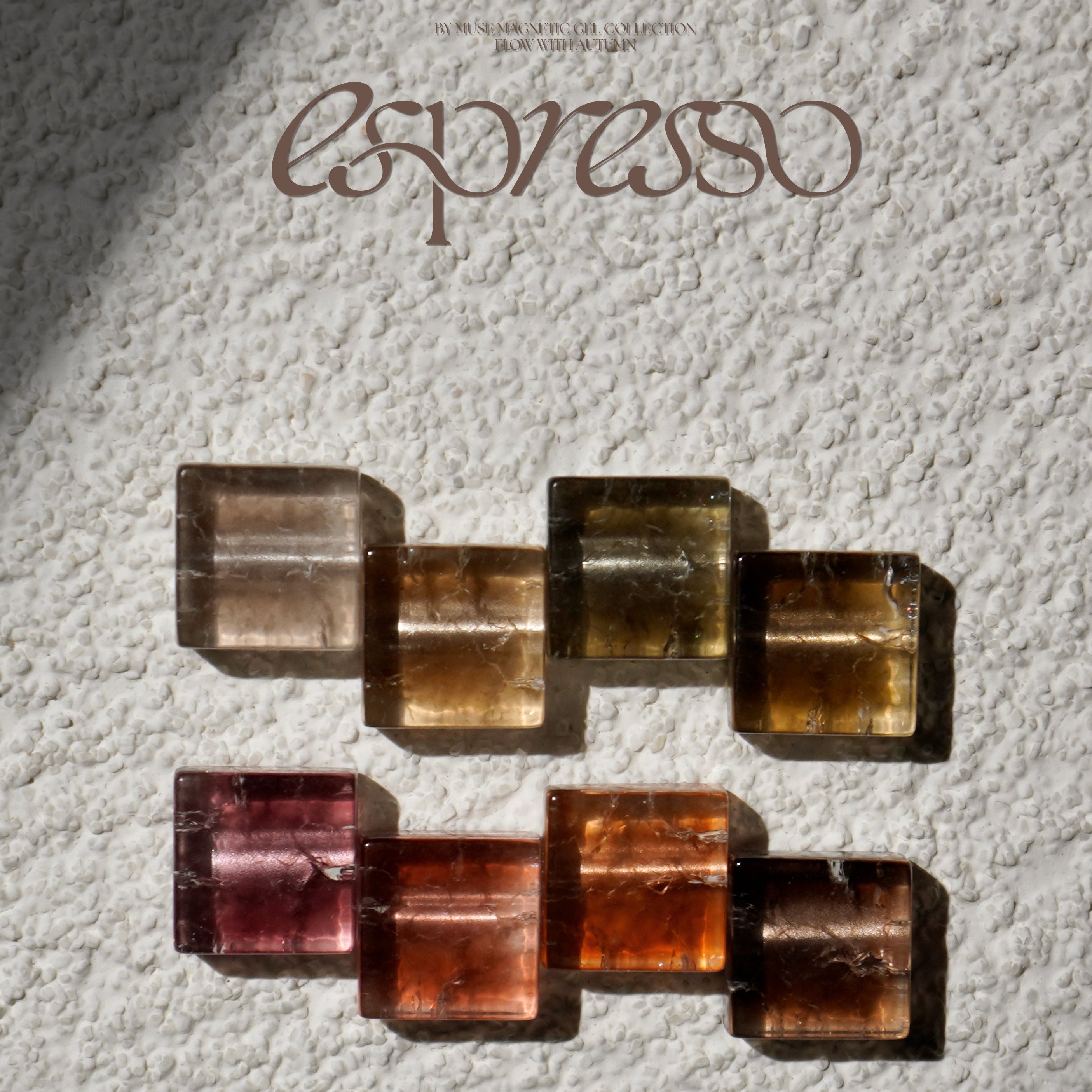 Colorful geometric stone arrangement on a textured surface with 'espresso' branding.